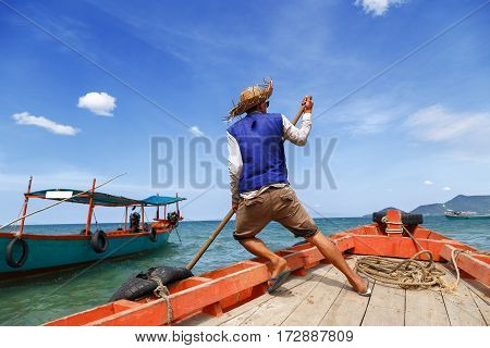 Boatman alone departs from the pier located on Rabbit island in Cambodia to send tourists to another pier