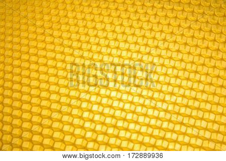 Empty honeycomb grid diagonal, brand- new beeswax, background texture