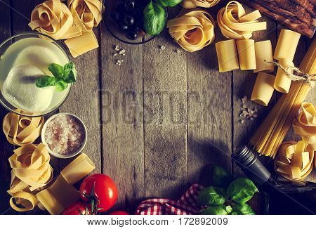 Tasty Colorful Fresh Italian Food Concept with Various Pasta Spaghetti Cheese Mozzarella Fresh Basil Tomatoes Olive Oil Spices. Cooking Concept. Place for Text. Toning.