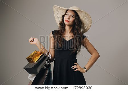 Beautiful woman with shopping bags. Studio shoot