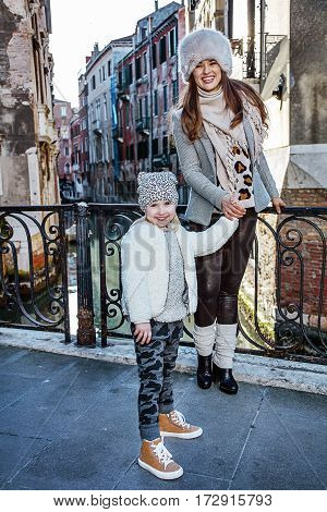 Mother And Daughter Tourists In Venice Having Walking Tour