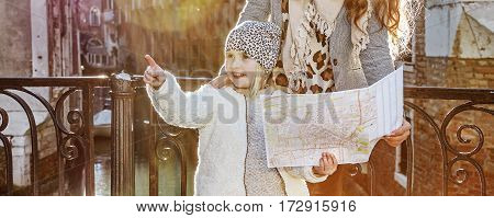 Mother And Child Tourists In Venice, Italy In Winter With Map