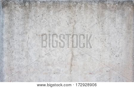Concrete grey wall texture background with cracks and holes