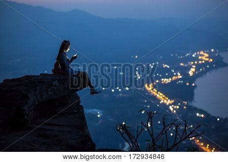 Beautiful Woman are using smartphone on after sunset on city blackgroud woman usesing smartphone in selfie