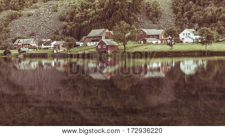 Norwegian Country Houses In The Mountains On Lake Shore