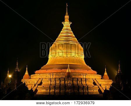 Beautiful view of the Dhammayazika Pagoda in golden light on the background of night sky. Bagan Myanmar.