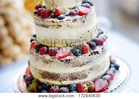 Delicious Chocolate Wedding Cake Decorated With Fruits And Berries