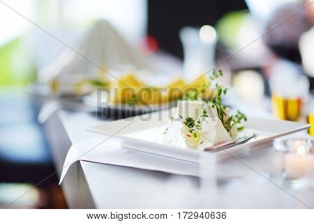 Different Kinds Of Wine Snacks And Variuos Cheeses On White Table