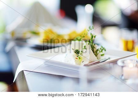 Different Kinds Of Wine Snacks And Variuos Cheeses On White Table