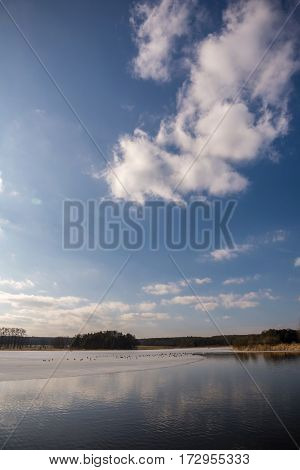 Early Spring Scene Of Partially Frozen Pond