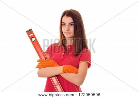 young attractive brunette woman in uniform makes renovation with tools in her hands looking away isolated on white