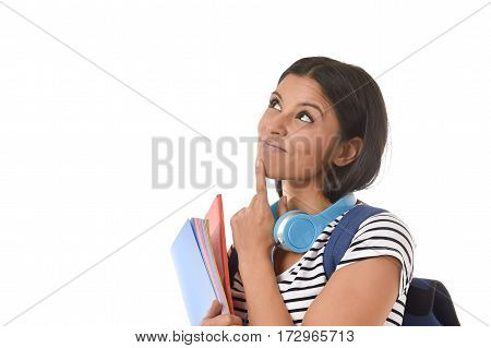 young beautiful and trendy latin student girl holding notepad folder and book carrying backpack smiling happy thinking in future university and college education isolated on white background
