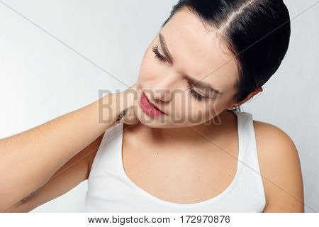 health people Sport and lifestyle concept - Tired Neck. Beautiful Young Woman Suffering From Neck Pain. Attractive Female Feeling Tired Exhausted Stressed. Girl Massaging Painful Neck With Hand.