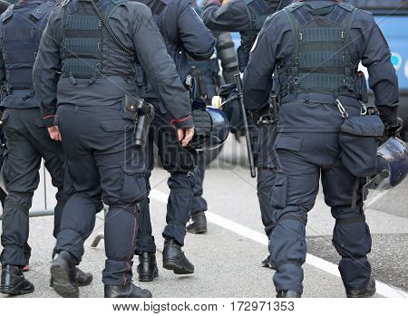 Police In Riot Gear With Protective Helmet Waiting For The Fans
