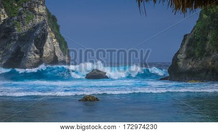 Huge Wave hitting the Rock in the ocean at Atuh beach on Nusa Penida island, Indonesia.