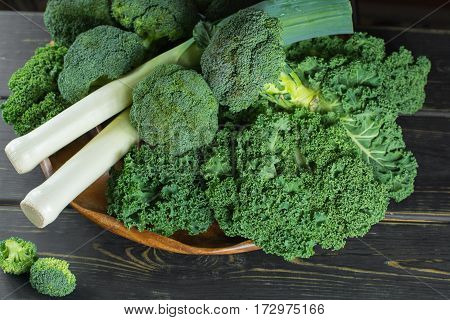 Green winter fresh organic superfood - Kale green cabbage broccoli and leeks prei