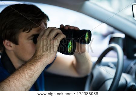 Private Detective Looking Through Binoculars Sitting Inside Car
