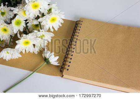 Blank area note book or diary with flower