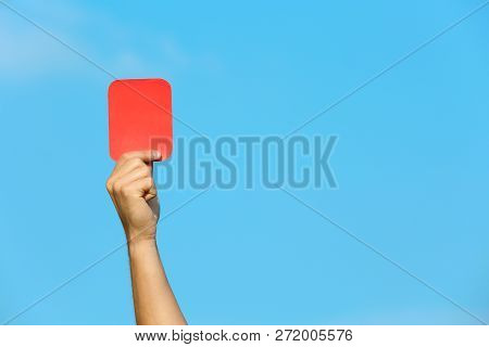 Football Referee Showing Red Card Against Blue Sky, Closeup With Space For Text