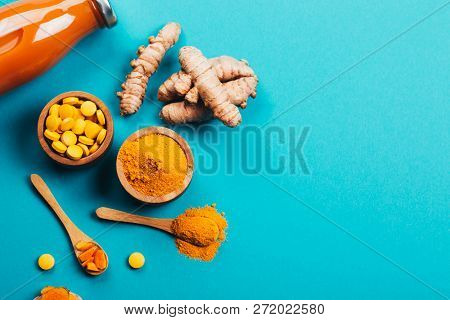 Mess Of Turmeric Plant In Different Conditions: Fresh, Dry Root, Pills, Powder And Cut Plant On Blue