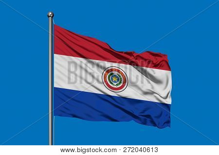 Flag Of Paraguay Waving In The Wind Against Deep Blue Sky. Paraguayan Flag.