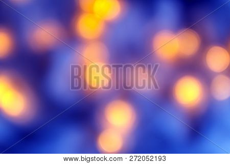 Background Of Blurry Blue-blue Lights Of The Christmas-tree Garland On The Dark. Copy Space
