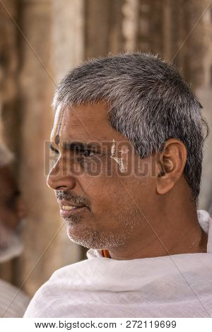 Belur, Karnataka, India - November 2, 2013: Chennakeshava Temple. Closeup Of Devotee With Vishnu Sym
