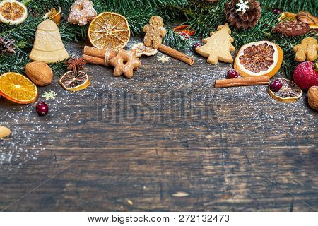 Christmas Background With Christmas Tree Branch, Festive Decoration, Dry Fruits, Home Made Cookies A