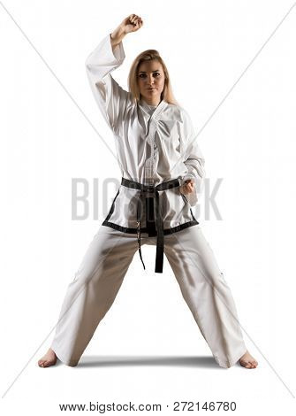 Woman in kimono practicing taekwondo. Isolated on white background