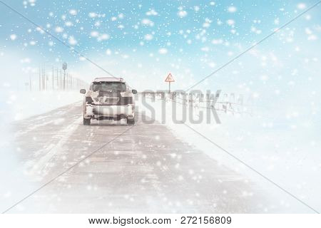 Winter, Snow, Blizzard, Poor Visibility On The Road. Car During A Blizzard On The Road With The Head