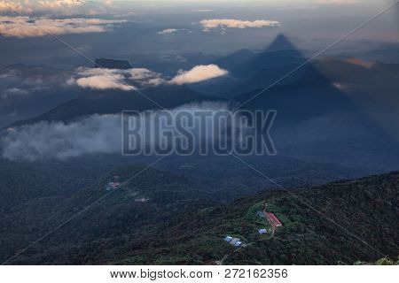 shadow of the conical mountain Adam's Peak or Sri Pada at sunrise - sacred buddhist place. Sri Lanka