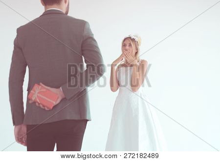Groom Hiding Red Gift Box Behind Back In Order To Surprise Bride On The Wedding Day,woman Positive E