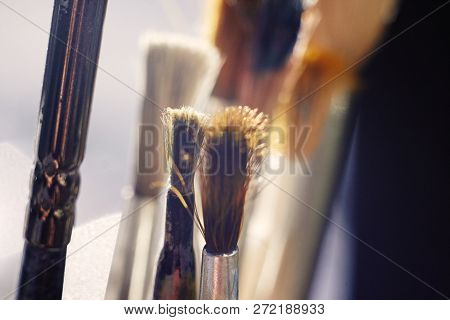 Several Brushes For Drawing, Sticking Out In Different Directions, Illuminates The Bright Sun