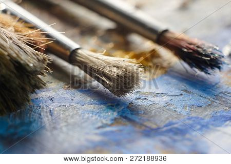 Brushes With Bristles On The Palette With Oil