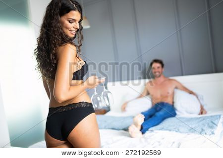 Attractive Sexy Woman With Her Partner In Bedroom