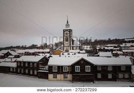 Winter In Roros, Original Mining Town. Snow Covered Roofs Of Old Buildings.