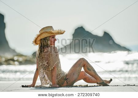 young woman relaxing on the beach in summer day