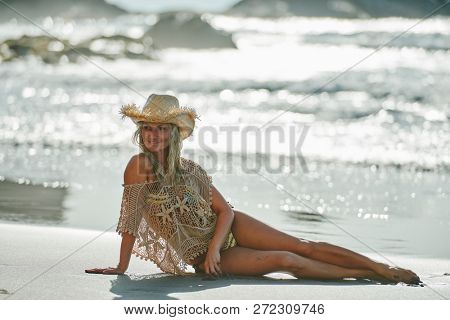 young woman relaxing on the beach in summer day