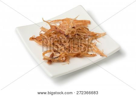 Dish with traditional dried shredded seasoned squid isolated on white background