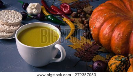 Pumpkin Asian Coconat Cream Soup. Autumn Hot Food. Chili Pepper, Garlic, Red Onion, Big Pumpkin. Dar