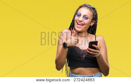 Young braided hair african american with birth mark using smartphone over isolated background happy with big smile doing ok sign, thumb up with fingers, excellent sign