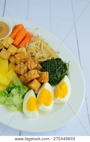 Gado-gado, Traditonal Indonesian Food. Boiled Vegetable, Egg, Tempeh, Tofu And Potato Served With Pe