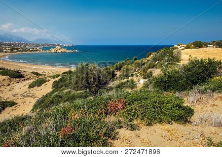 Desert Coastline With Sand Alagadi Beach Of Northern Cyprus And Factory And Mountains On Horizon