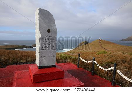 Cape Horn, Chile - October 31,2018: Monument On Hornos Island. In The Background Tourists At The Alb