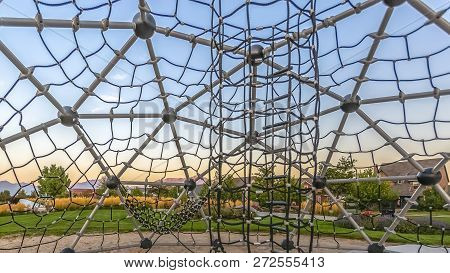 Dome Climber Overlooking Homes Park And Sky