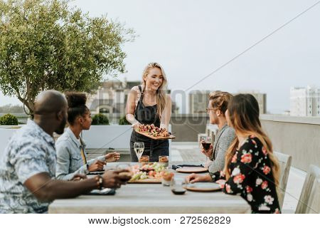Woman serving vegan barbecue to her friends