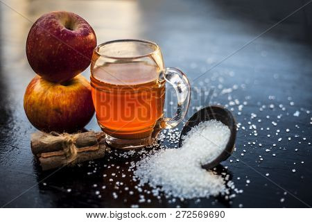 Apple Juice In A Transparent Glass With Two Raw Apples In  Side,close Up View.