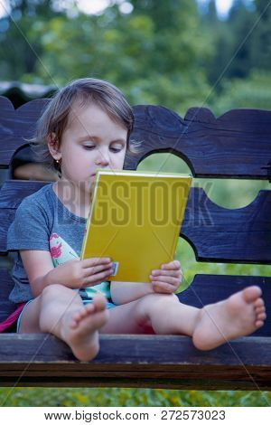 Little Cutechild Girl Watching A Book (science, Education, Knowledge, Success Concept)