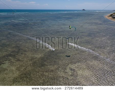 Kiteboarding, Kite Surf. Extreme Sports Kitesurfing In Tropical Blue Ocean, Clear Beach. Aerial View