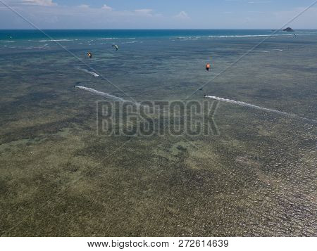 Kiteboarding, Kite Surf. Extreme Sport Kitesurfing In Tropical Blue Ocean, Clear Beach. Aerial Views
